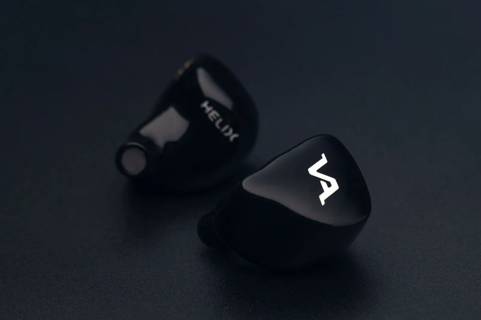 Virtus Audio Helix — pair on a black backdrop, the name engraved on the gloss-black shell beside the Virtus mark on the faceplate