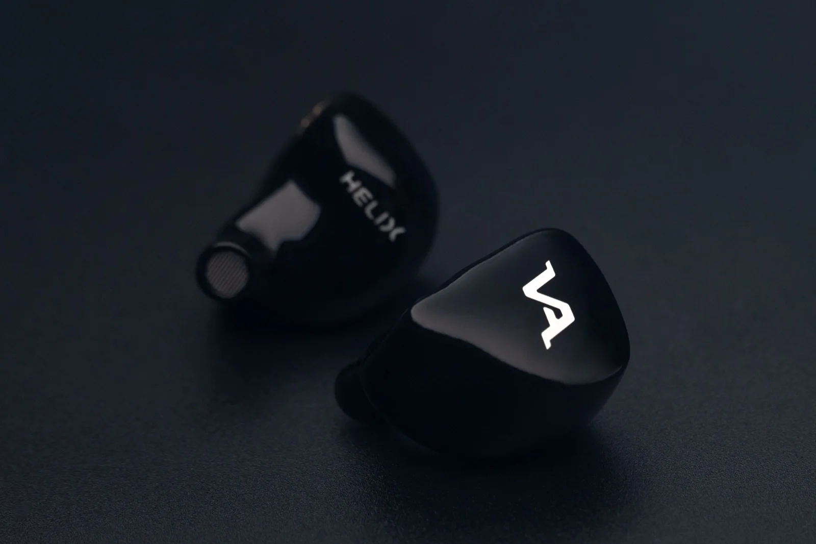 Virtus Audio Helix — gloss-black pair, the name engraved on one shell and the Virtus mark on the other